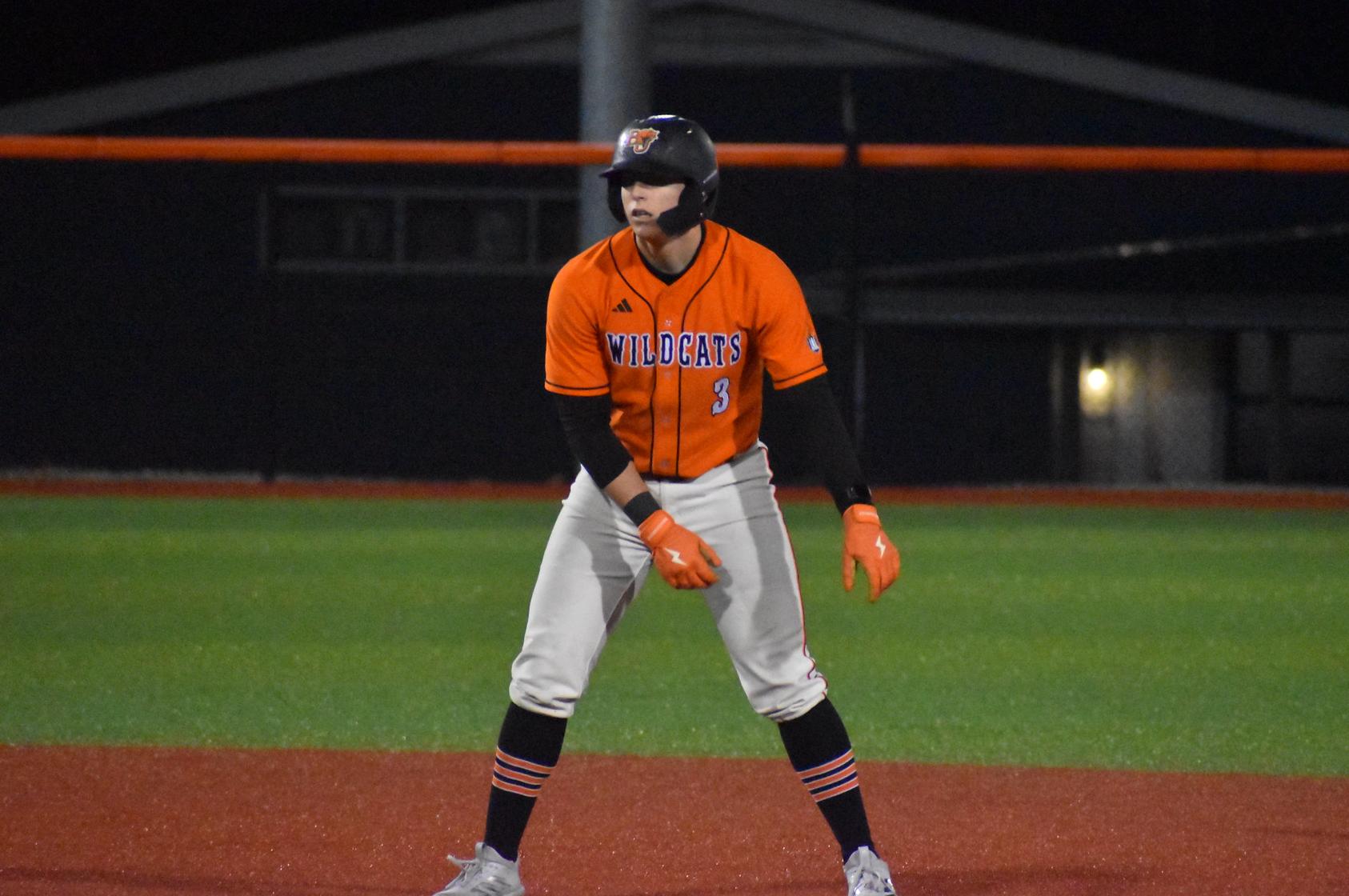 Baker baseball infielder Jackson Truman running at second base at home against Viterbo