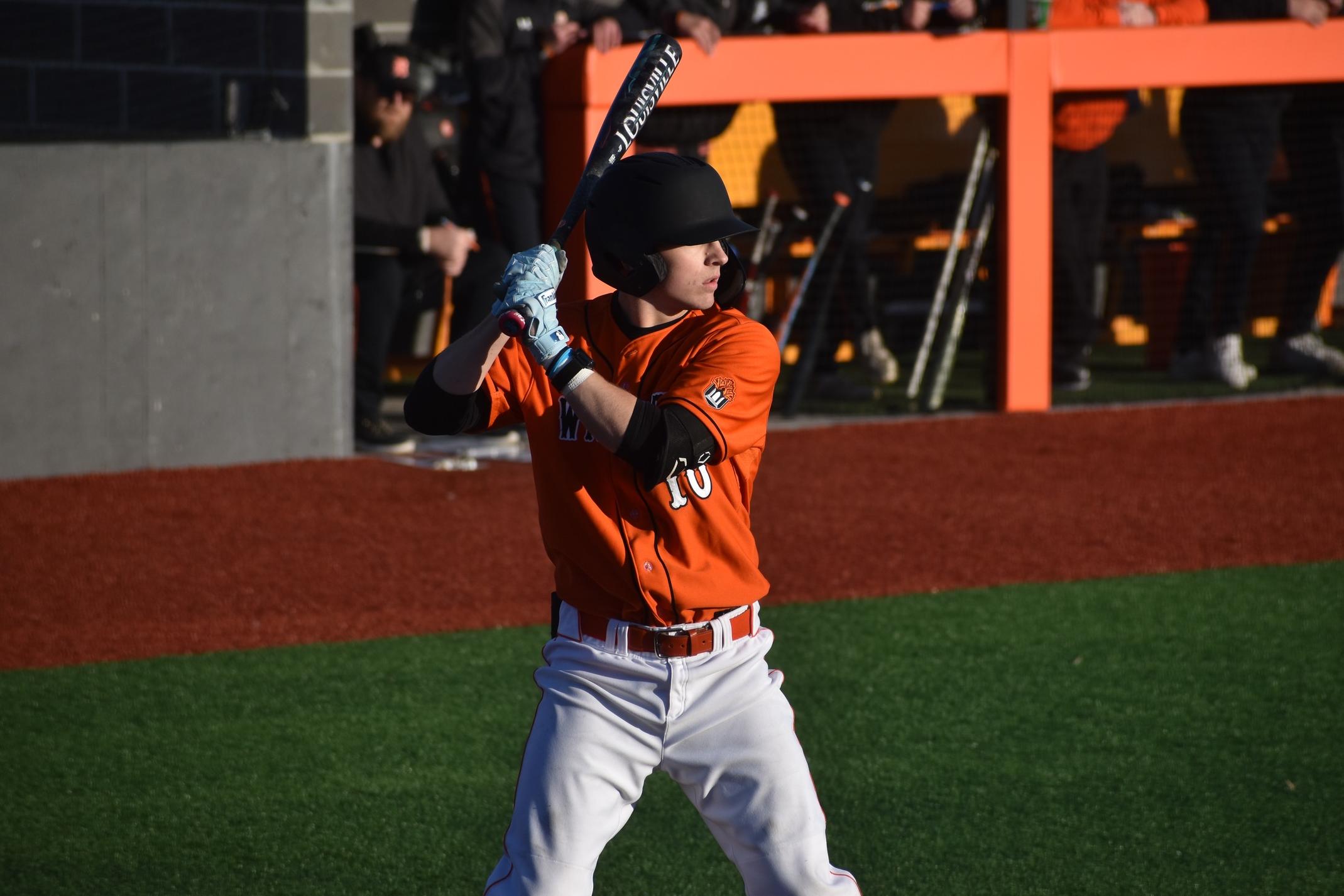 Baker baseball player Tyson Kiser hitting at home