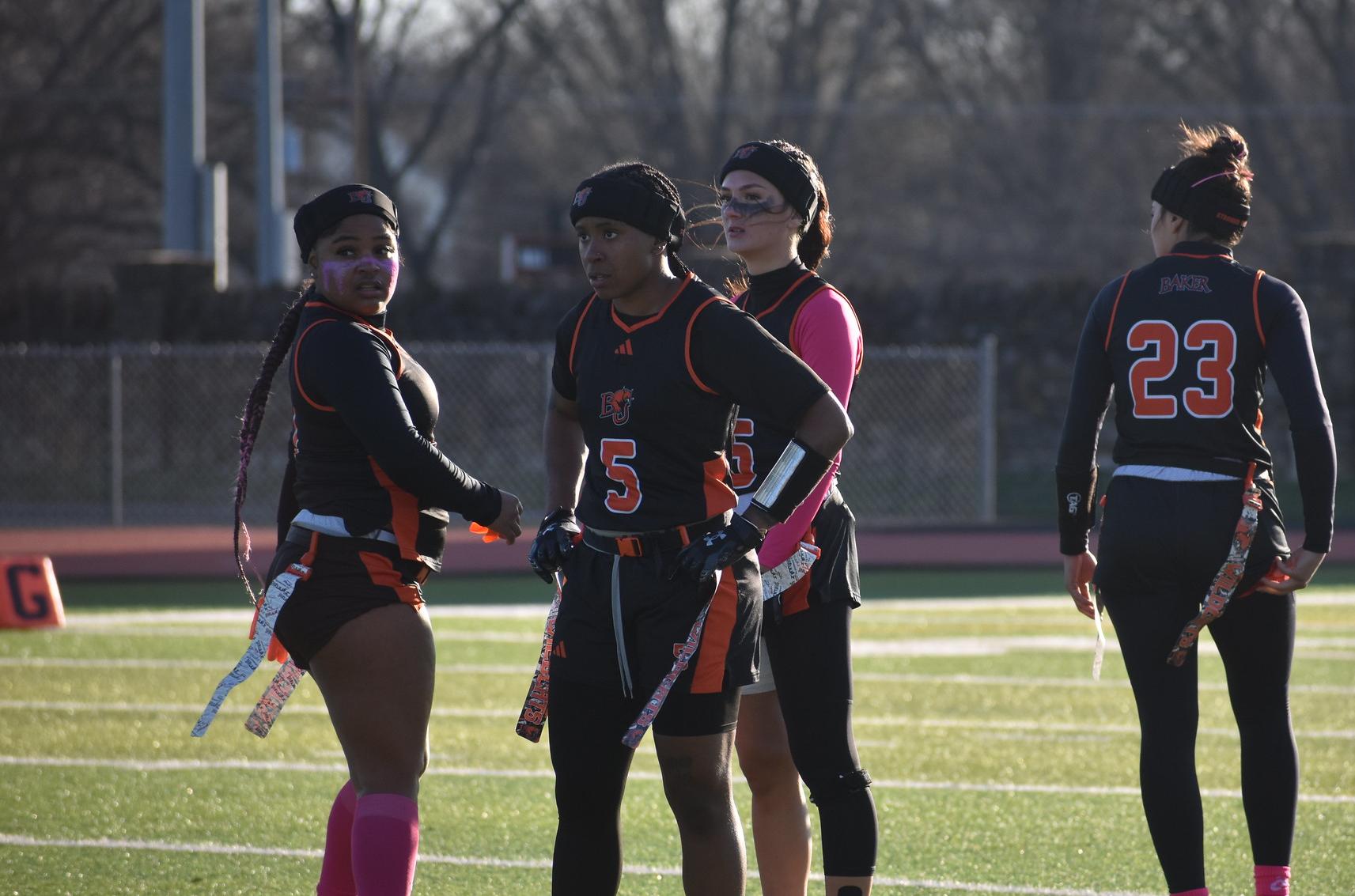 Baker women's flag football defensive huddle at home against Ottawa