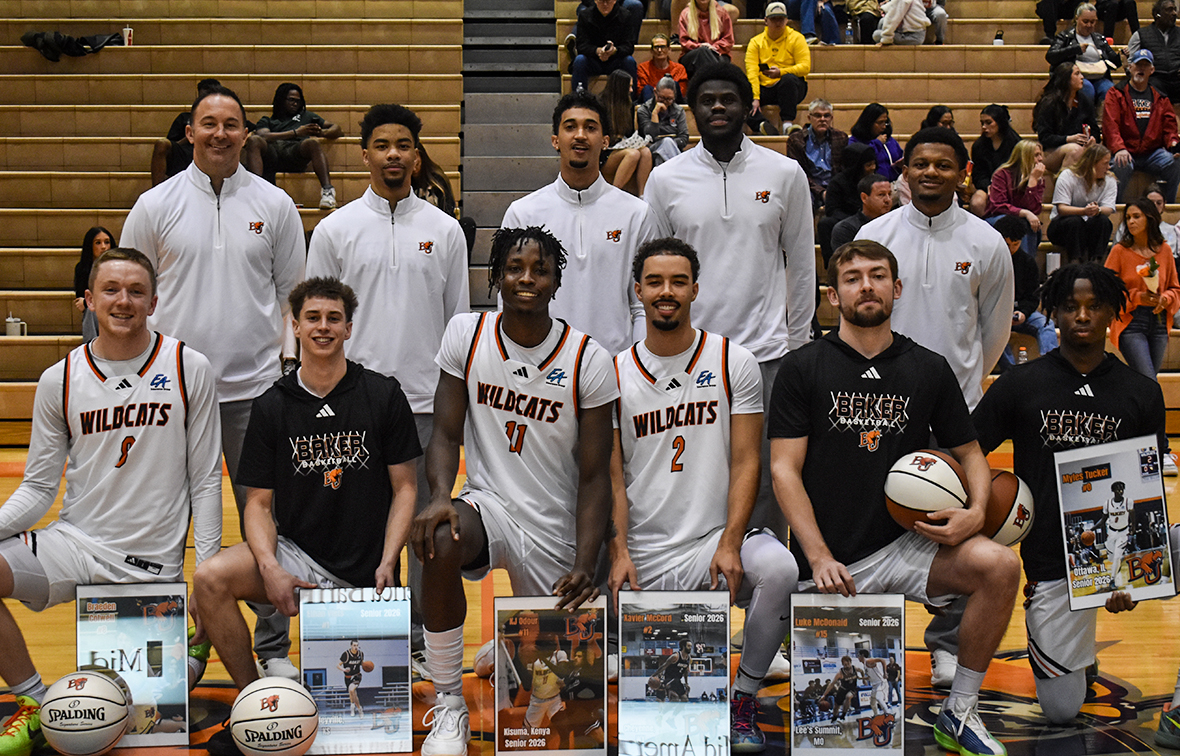 Senior Day picture for Baker men's basketball, featuring, from left-to-right, top row: head coach Sean Dooley, assistant coach Joshua Kelly, assistant coach Kaimen Lennox, assistant coach Ahmed Mahgoub, assistant coach Nick Whittick, front row: seniors, Braeden Colwell, Ethan Viets, KJ Odour, Xavier McCord, Luke McDonald and Myles Tucker.