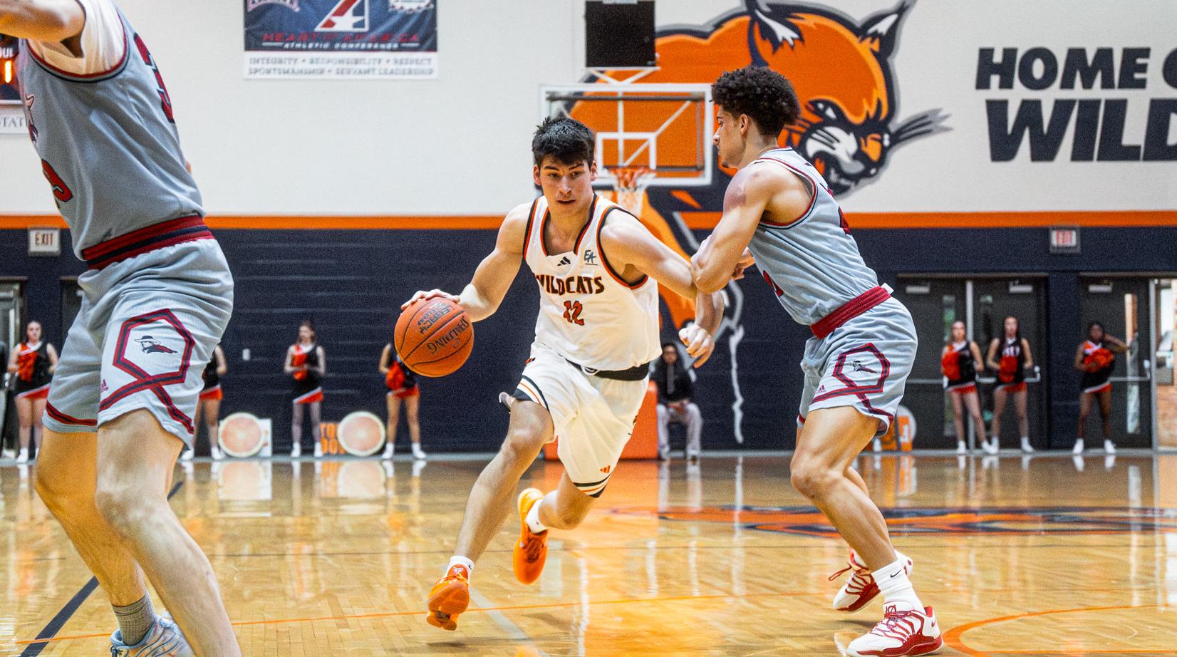 Cam Jones driving by a defender