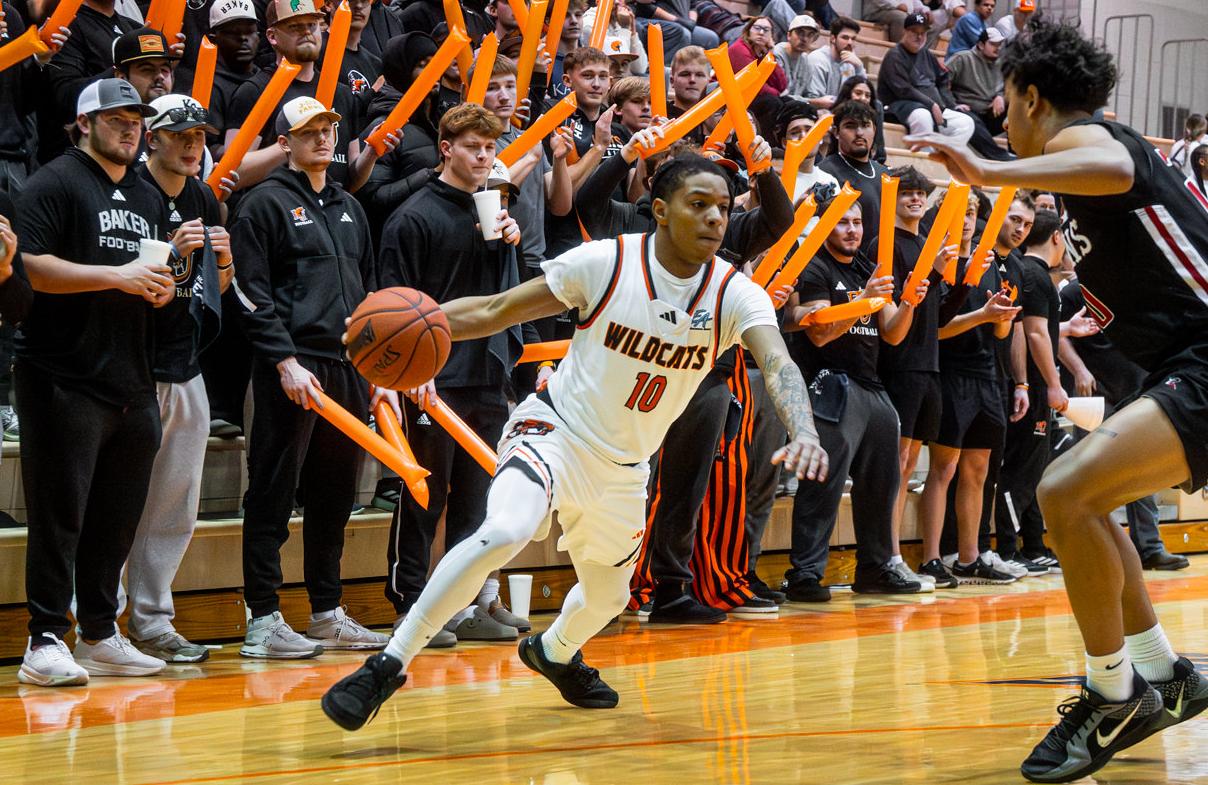 Baker men's basketball point guard Alex Gunnels dribbling against Benedictine in the Collins Center