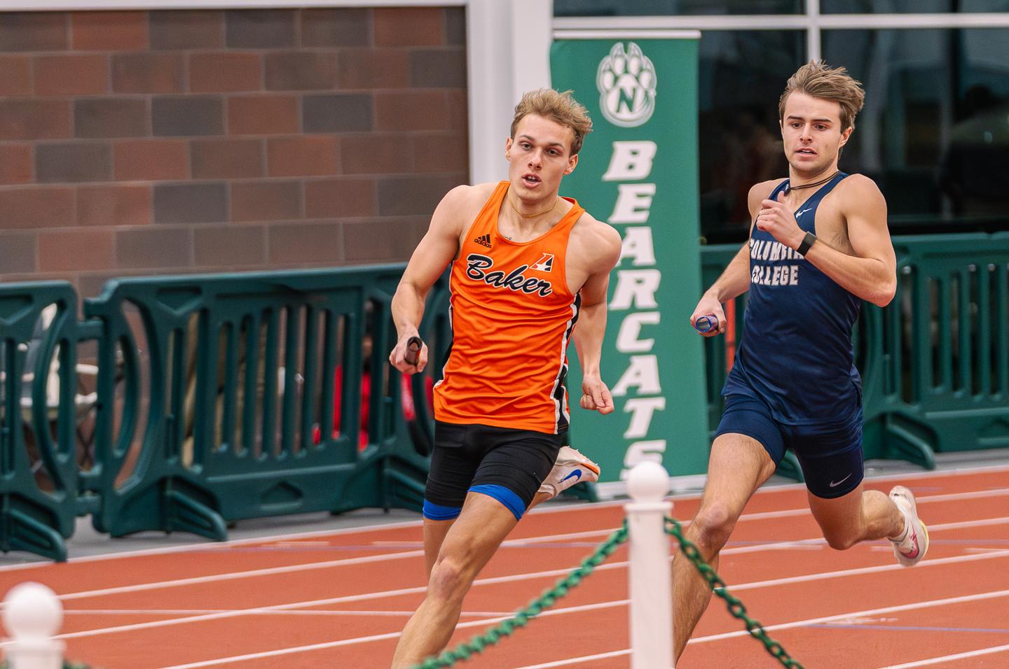 Trot Wood running an indoor relay at Northwest Missouri State