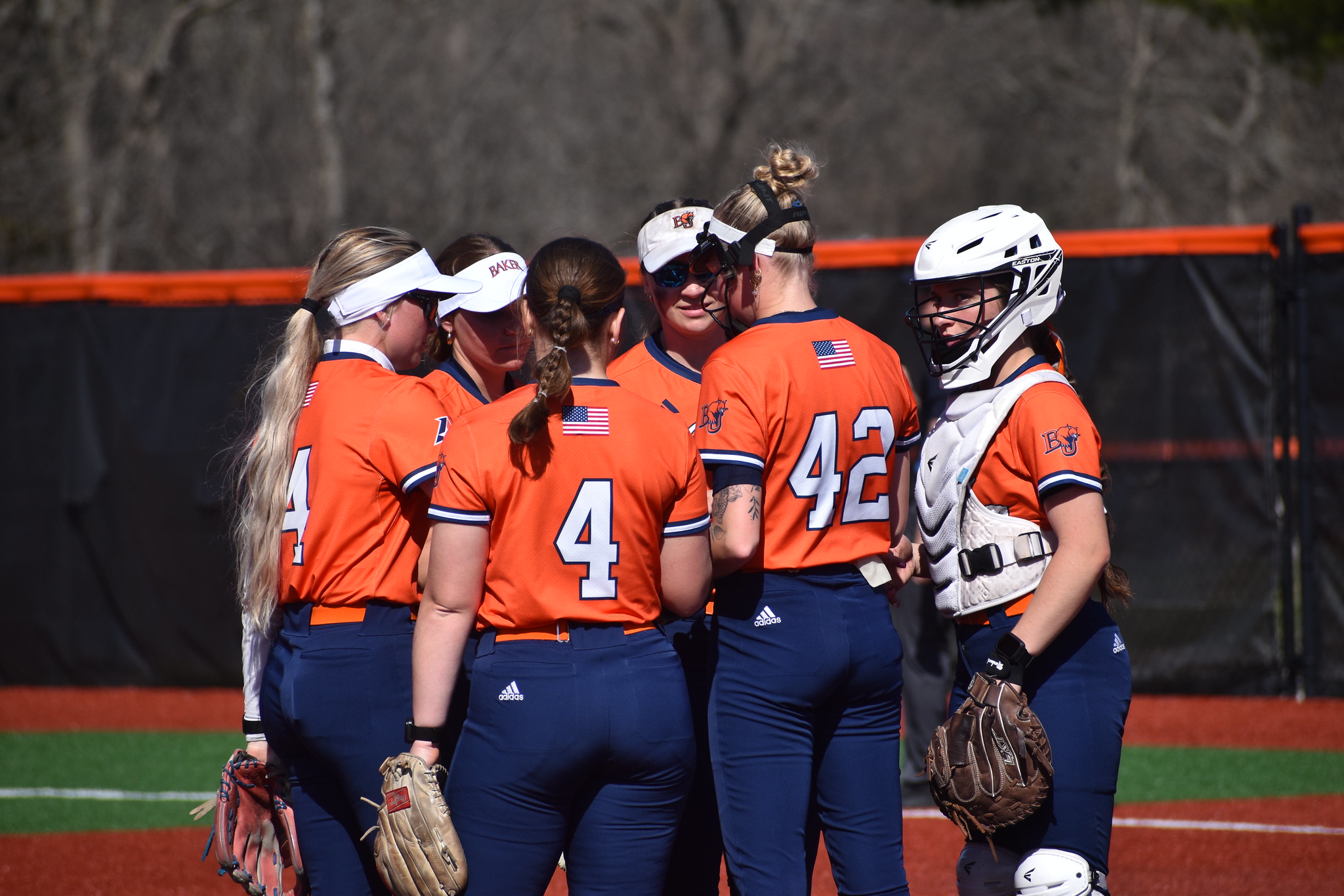 Baker softball defensive huddle at home against Missouri Baptist