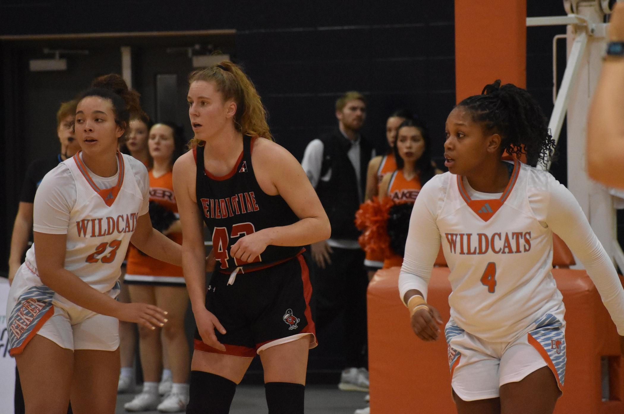 Baker women's basketball players Corrine Cole and Taniya Tease playing defense at home against Benedictine